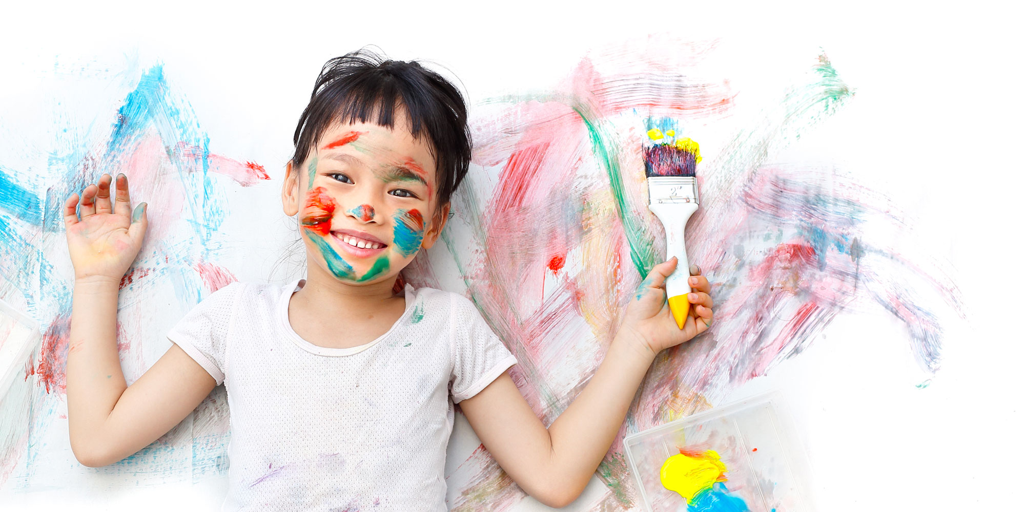 little girl painting, covered in paint