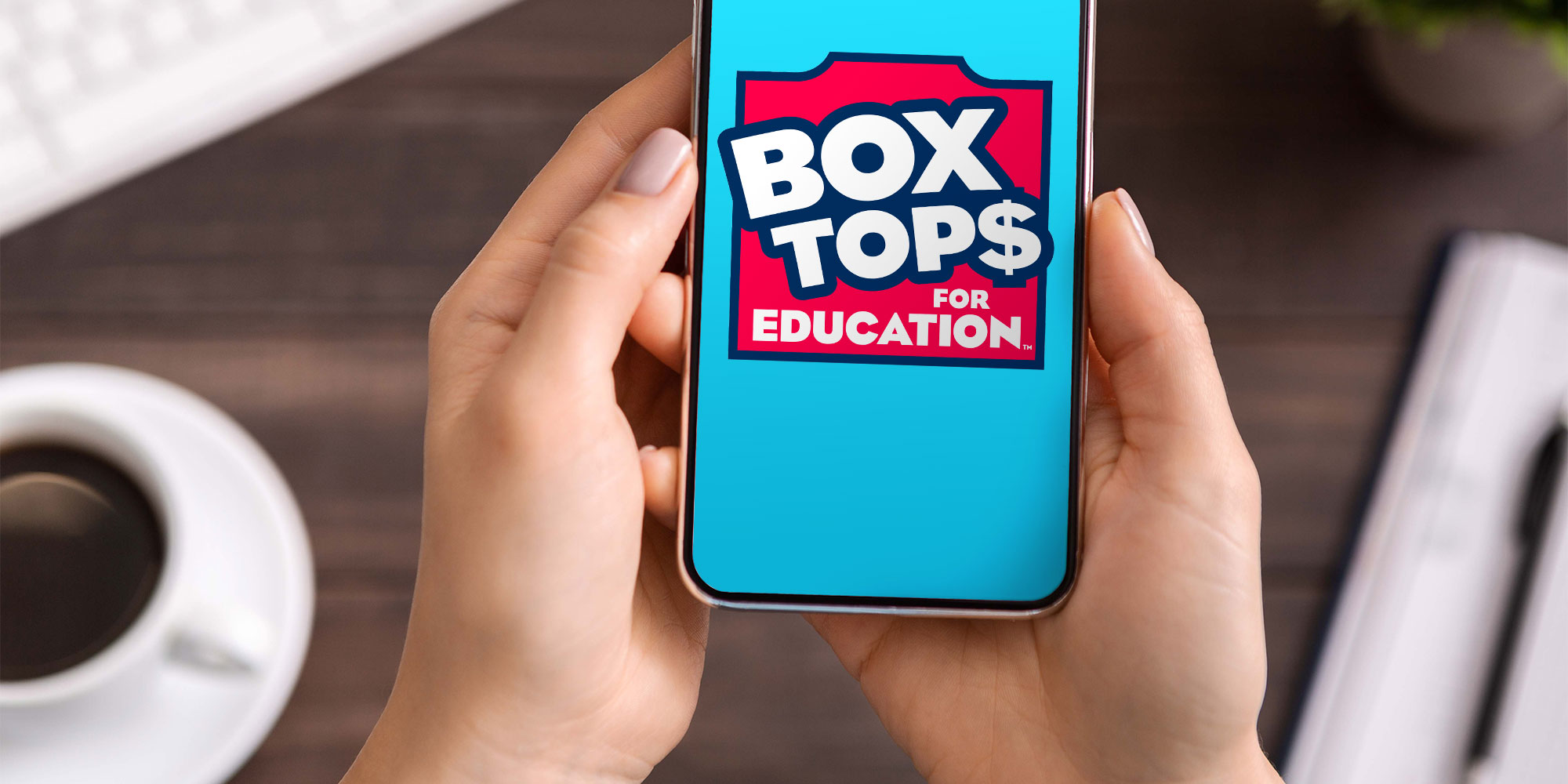 Smart phone in hands, phone screen displays Box Tops for Education
