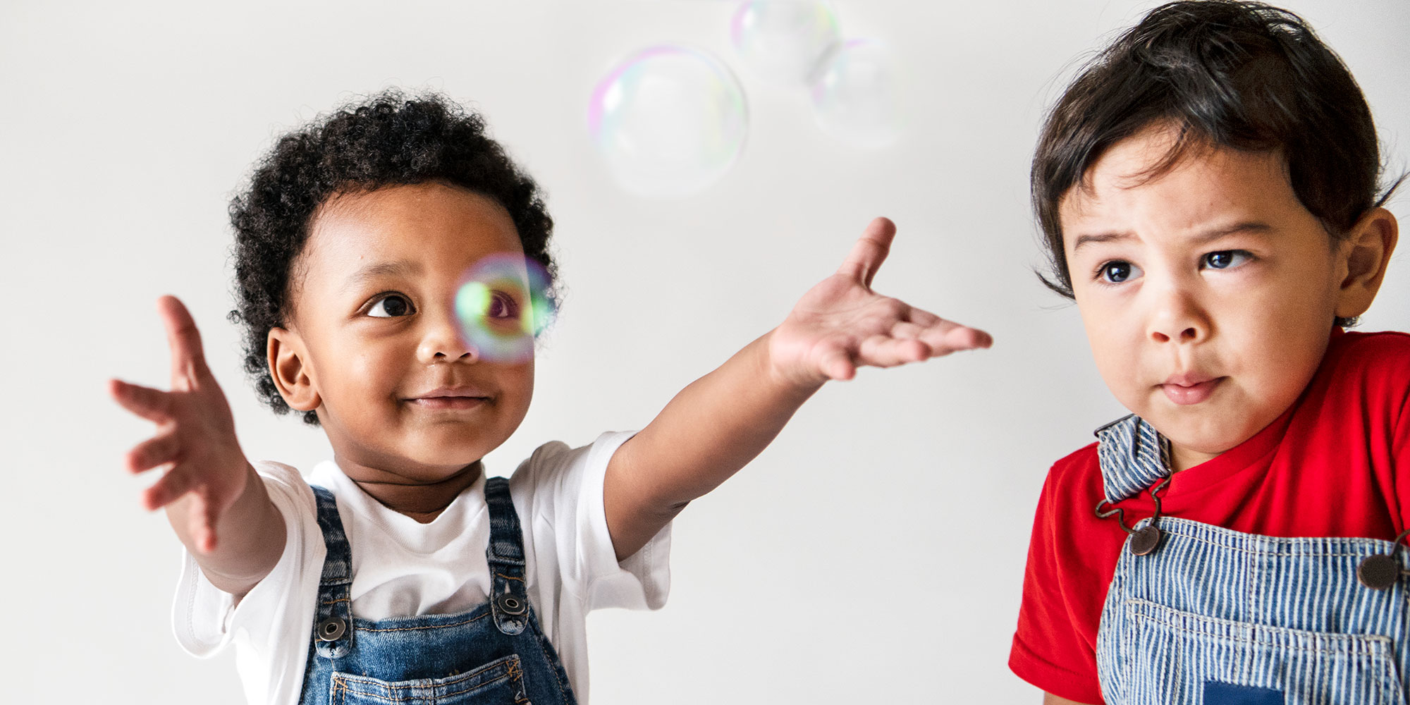 Two boys playing with bubbles