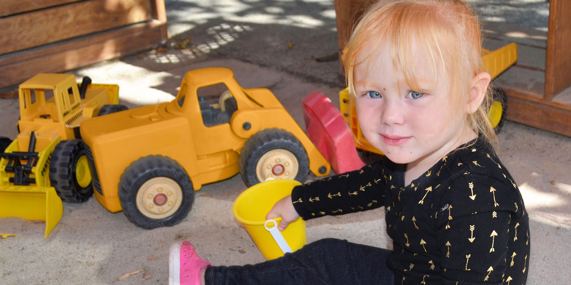 Girl playing with toy trucks