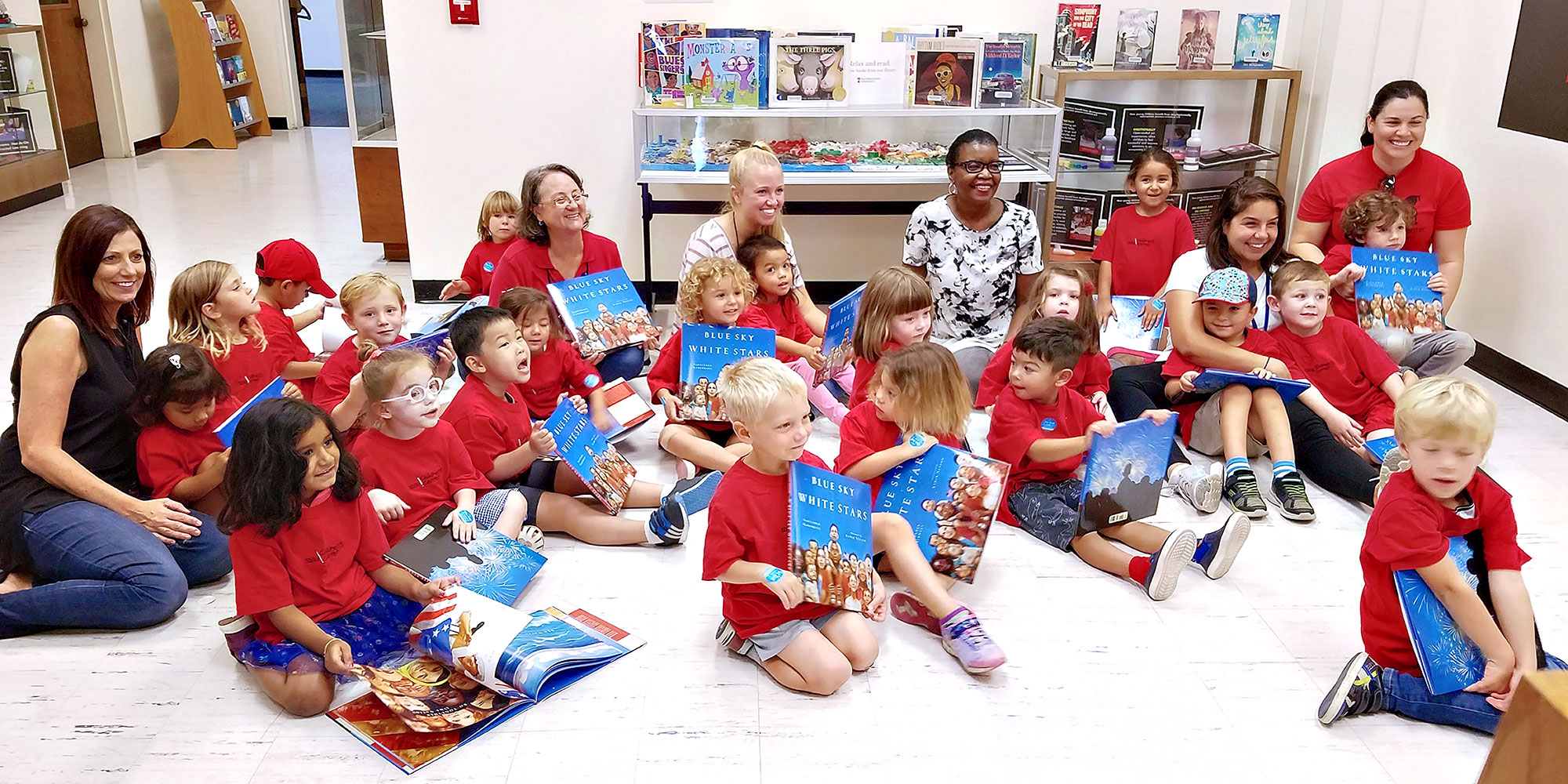 Children's Center Teachers with students reading books